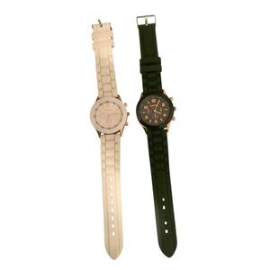 Two women’s watches. One white and one black. Both have rose gold numbering.